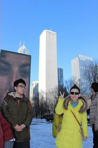 Students posing in front of a tall building